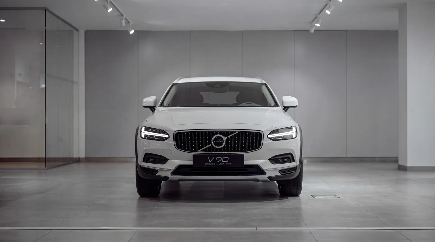 White Volvo estate car in a bright, empty showroom